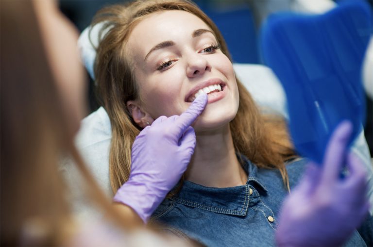 a dentist is checking the teeth of a person