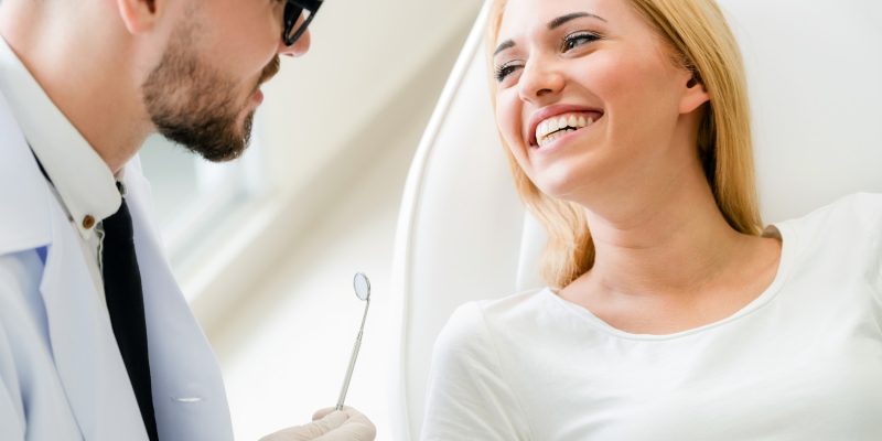 a person is smiling after having conversation with the dentist